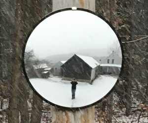 convex mirror reflecting artist taking photo