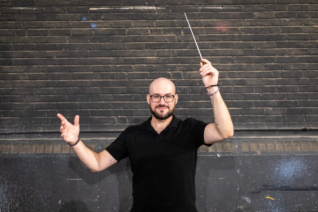 Photo of Kevin Lawson, MFA Theatre: Musical Theatre Directing student on the stage of Taylor Theatre where he will music direct the School of Theatre’s production of Andrew Lippa’s Wild Party opening November 11th. Photo credit: Mike Micchiche.