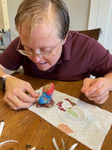 Peacehaven Community Farm core member Anne H. making tiny art for the mini-museum at Greensboro Project Space