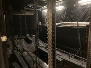 Below the stage in UNCG Auditorium is the mechanism that raises and lowers the orchestra pit.