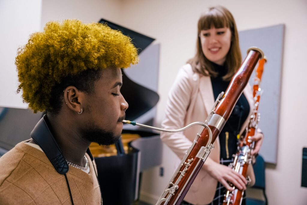 Kassie Ormsby teaching Avery Beckham on bassoon