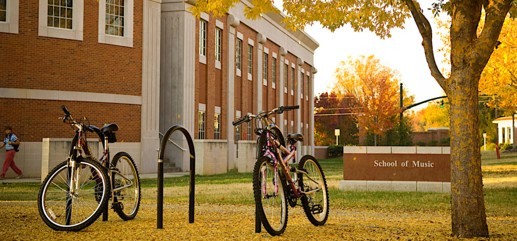 Image of the Music Building, sign and bicycles.