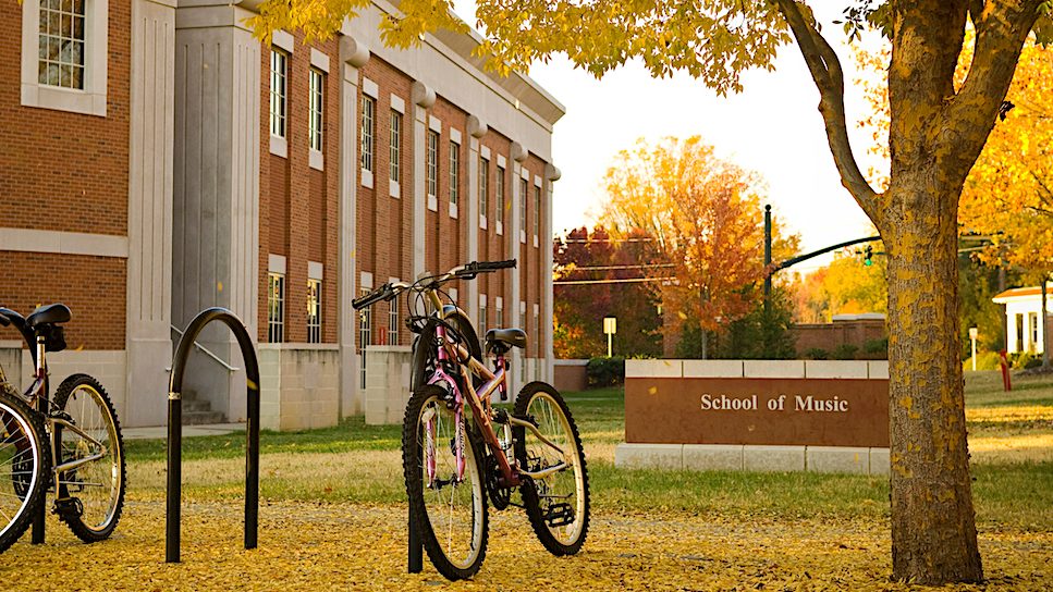 Image of the Music Building, sign and bicycles.
