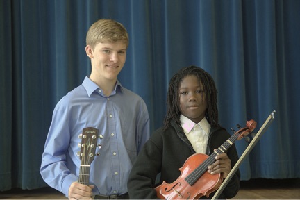 student and teacher with violin