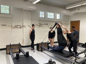 Mila Parrish (Professor of Dance) working with students in the School of Dance's new Pilates certification class. 