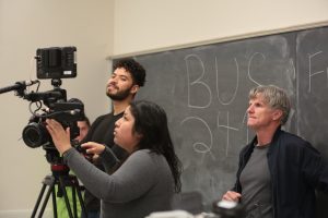 Liam Roos, Yisel Ortiz, and Associate Professor Michael Flannery checking footage during production of the School of Theatre’s web series I ❤️ Collaboration. Photo credit: Jannida Chase