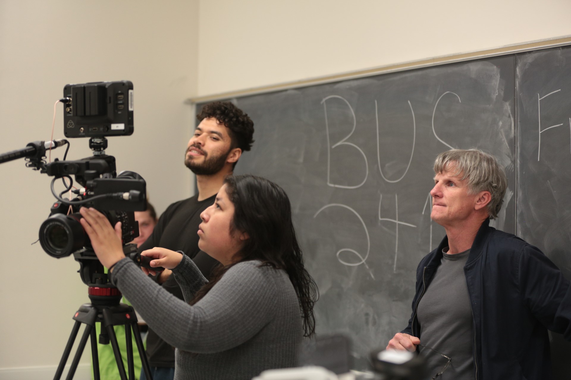Liam Roos, Yisel Ortiz, and Associate Professor Michael Flannery checking footage during production of the School of Theatre’s web series I ❤️ Collaboration. Photo credit: Jannida Chase