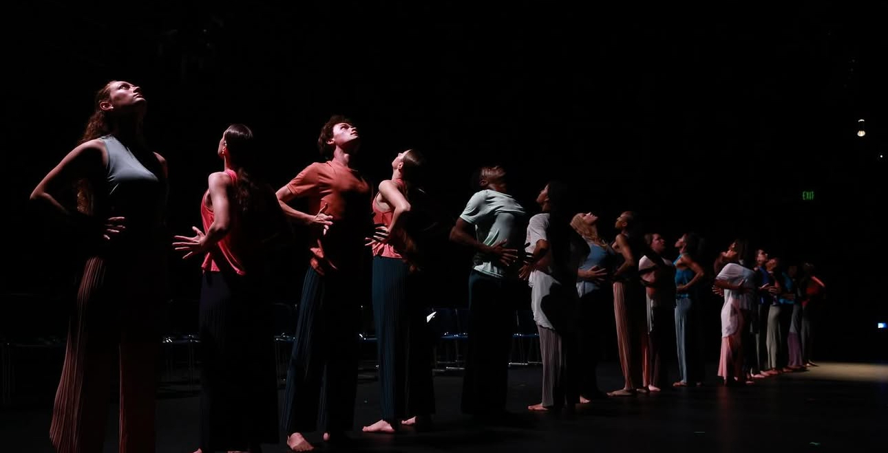 A line of students dancing on stage
