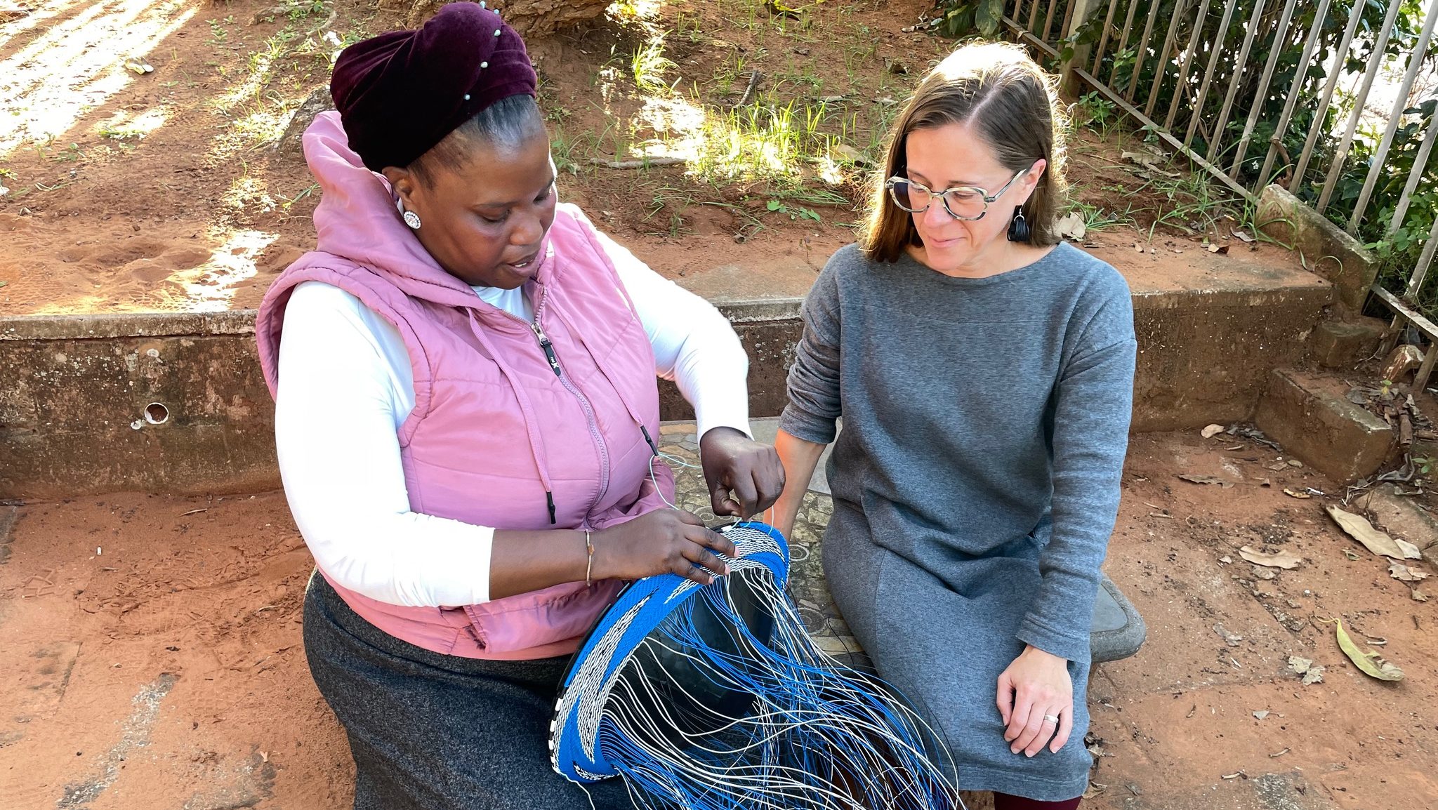 Bongeleni Mkhize and Dr. Perrill discussing weaving patterns. Phansi Museum, Durban, South Africa. July 2023