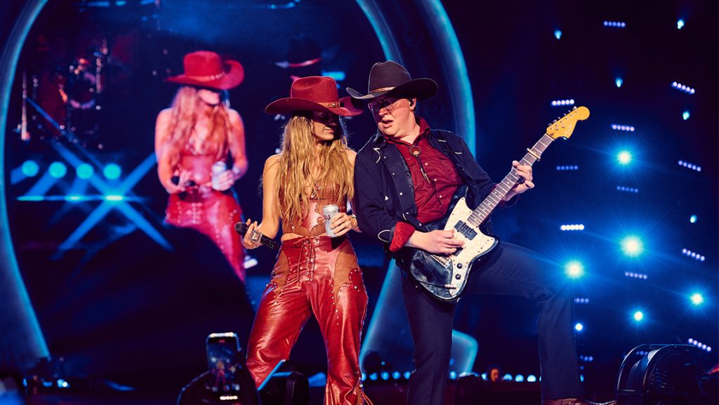 Aslan Freeman '11 on stage with Country Star Lainey Pope